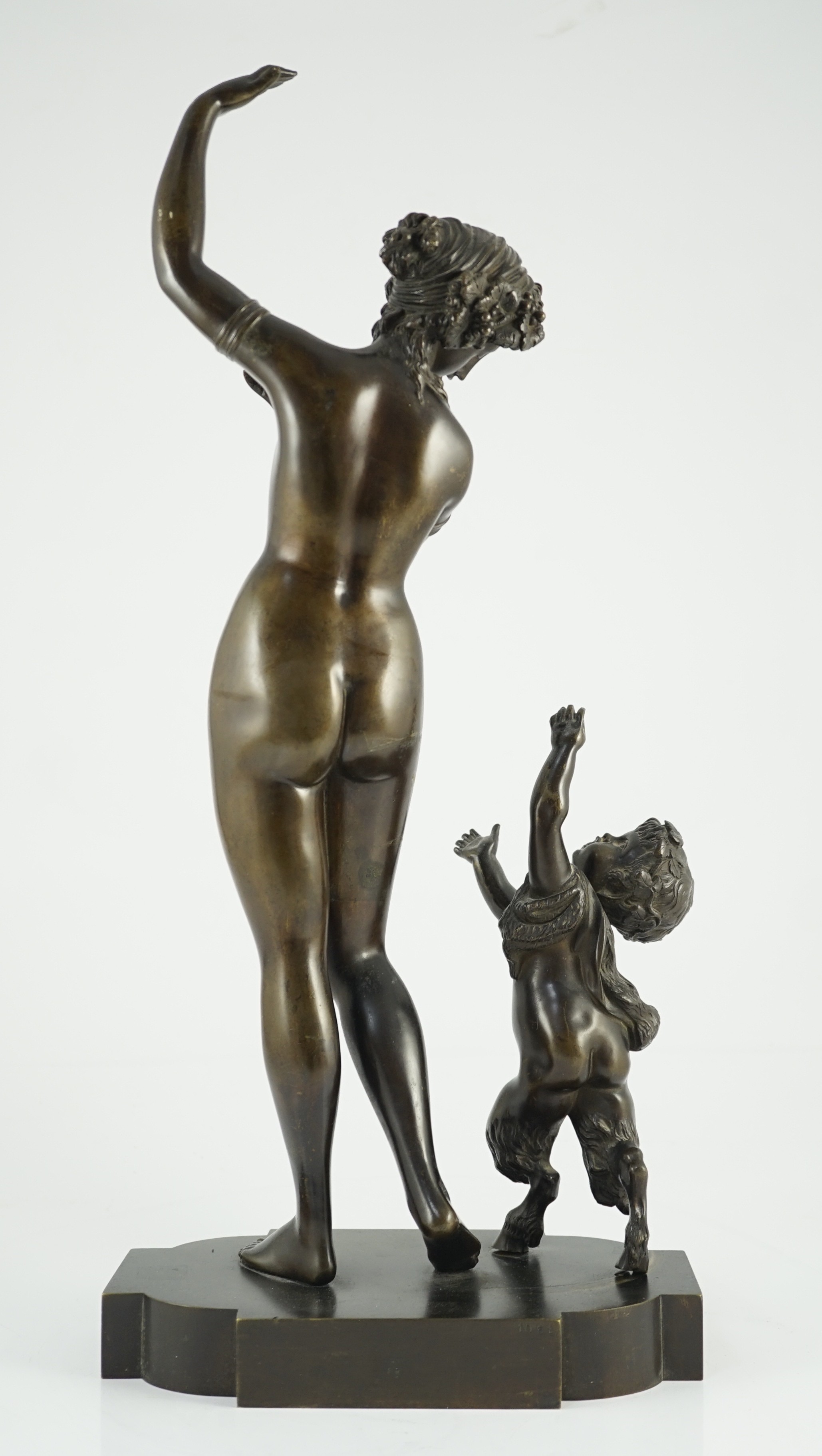 A 19th century French bronze group of a muse dancing alongside a faun, 24cm wide, 52cm high